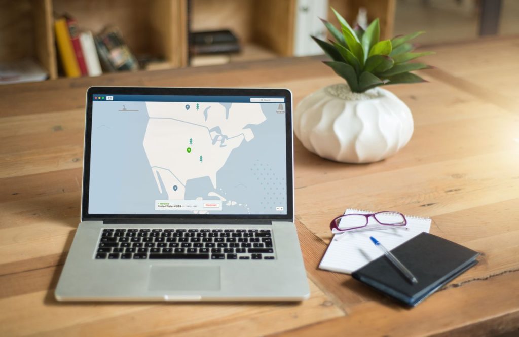 pexels photo 1901388 1901388 A laptop displaying VPN software sits on a wooden desk with a notepad and plant offering a secure workspace vibe.